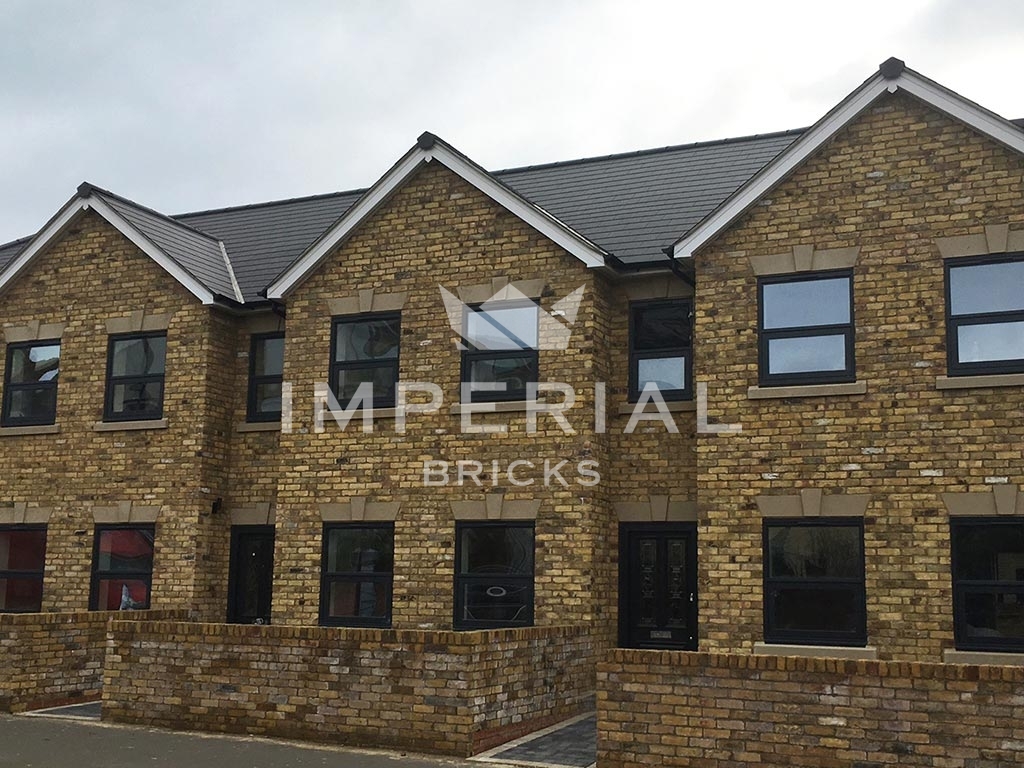 Angled view of front of new build development built with Reclamation Yellow Stock handmade bricks