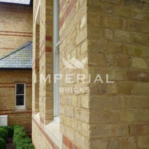 Corner of residential extension built using Cambridge Buff handmade bricks. Image is taken close up to show the detail and texture in the brickwork.