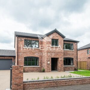 Detached residential new build home with a double garage, built using Reclamation Red Handmade bricks.