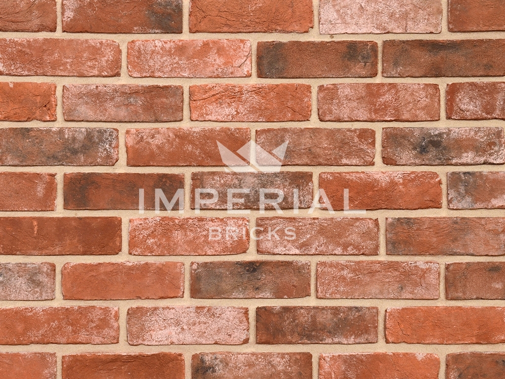 Reclamation Weathered Soft Red bricks shown in a wall. The bricks are weathered, mortared and blended to replicate the look of genuine reclaimed bricks.