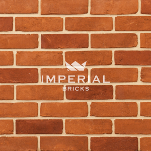Regency Orange Multi handmade bricks shown in a wall. The bricks are orange blended with some red shades.