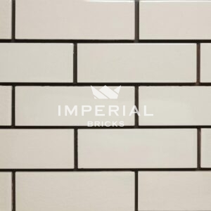 White brick tiles with a crackled patterned surfaces and a high sheen finish.