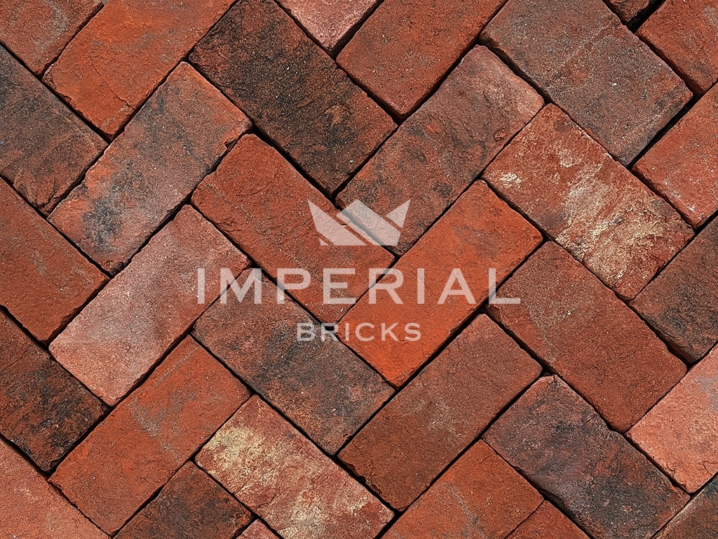 Sandringham Blend pavers laid in the ground. The pavers are blended red and orange colour shades with a weathered and aged finish.